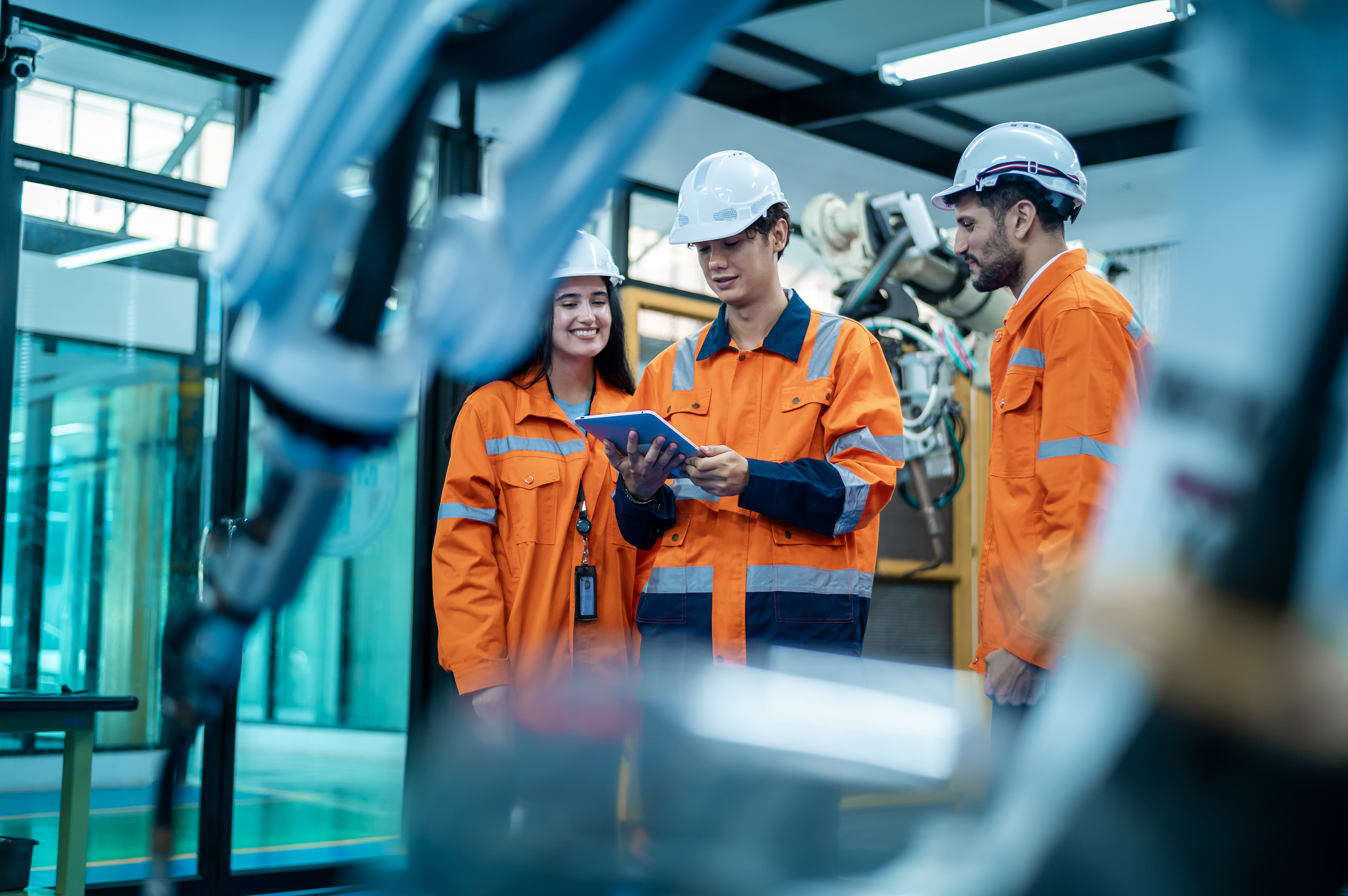 Manufacturing team collaborating on factory floor
